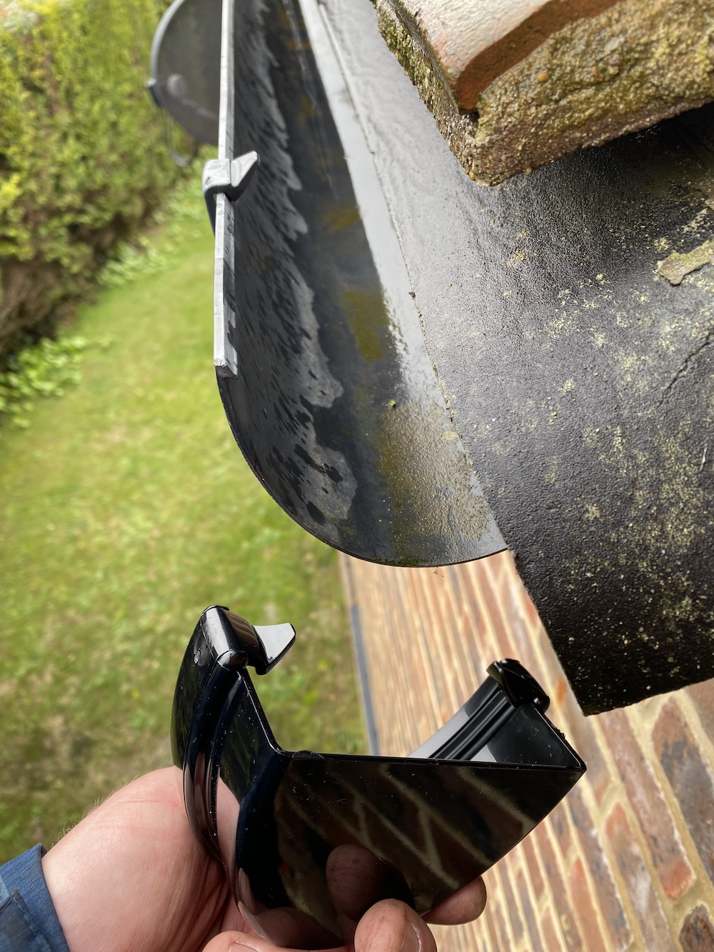 A stop end being fitted to the end of a gutter.
