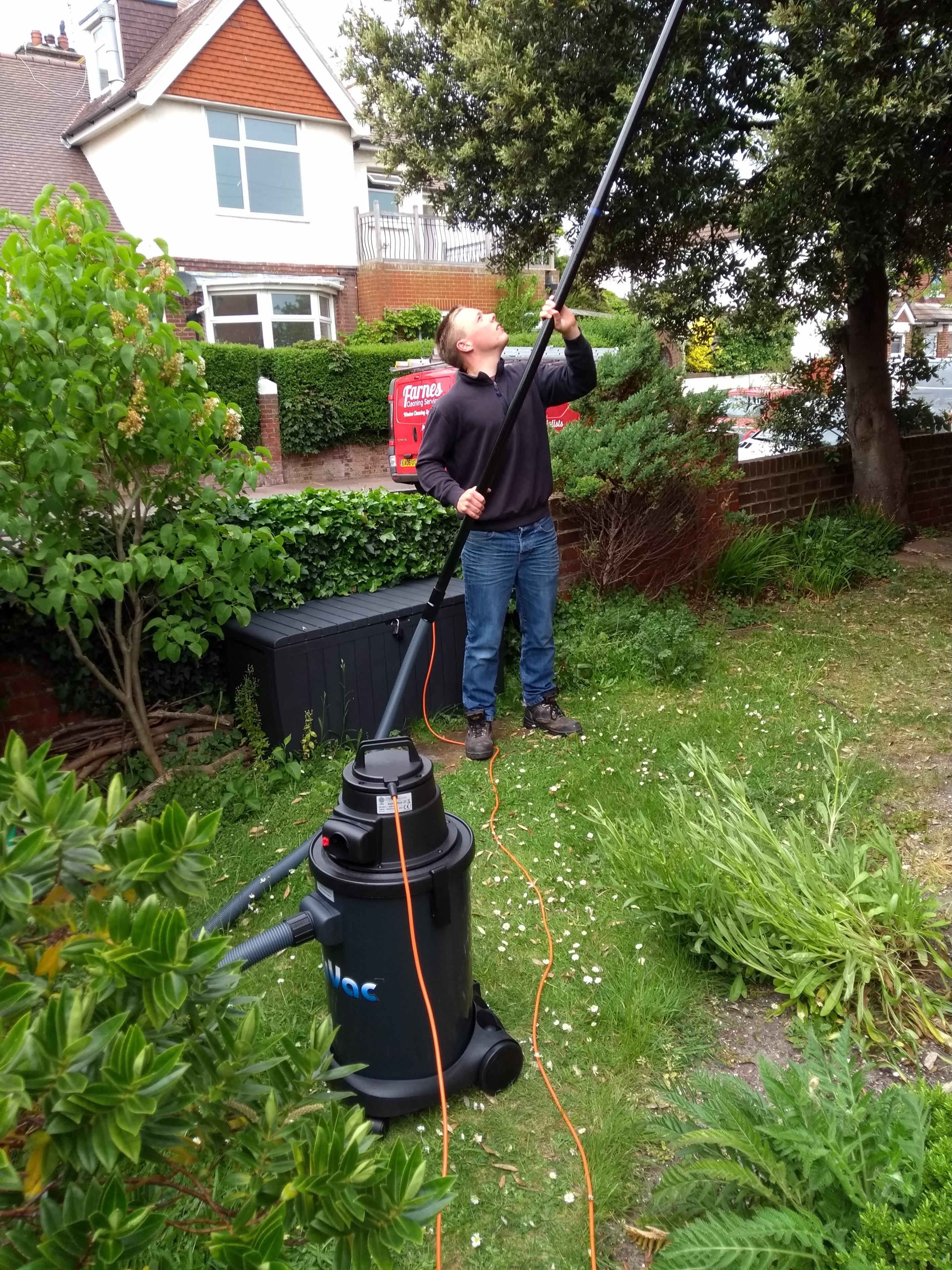 A SkyVac gutter vacuum in use.