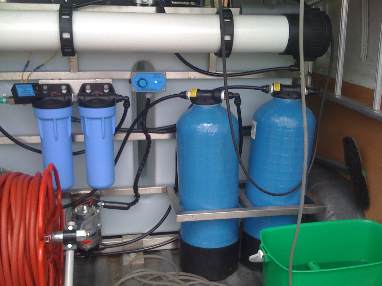 Water-fed-pole equipment in the back of a van.